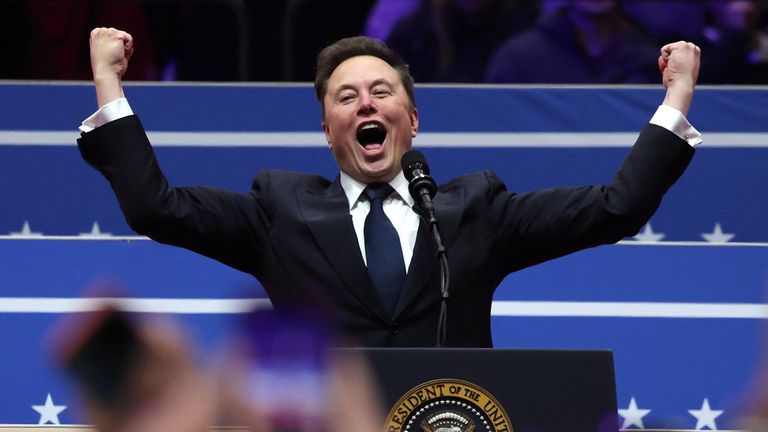 Elon Musk gestures at the podium inside the Capital One arena.
Pic: Reuters