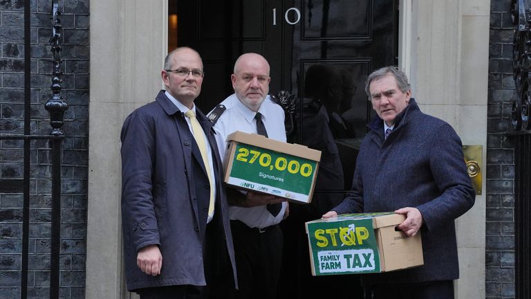 NFU president Tom Bradshaw (L) and NFU Cymru president Aled Jones (R) hand in a petition at 10 Downing Street. Pic: PA