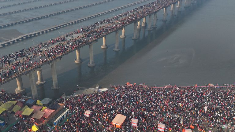 The banks and a bridge over the Ganges full of people on Wednesday. Pic: AP