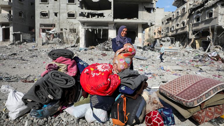 A Palestinian woman reacts as she returns to her destroyed house, following a ceasefire between Israel and Hamas, in Jabalia in the northern Gaza Strip, January 19, 2025. REUTERS/Dawoud Abu Alkas

