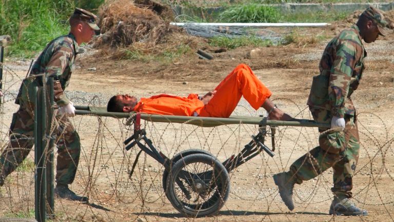 A detainee from Afghanistan is carried on a stretcher before being interrogated by military officials at Camp X-Ray at the US naval base in Guantanamo Bay. Pic: AP