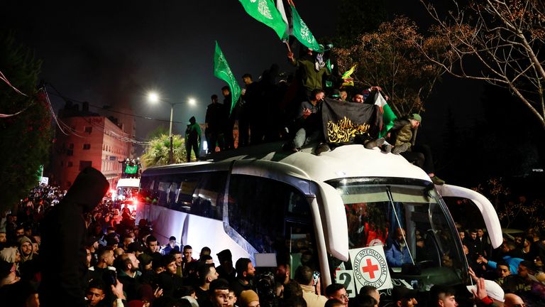 People gather around a bus carrying freed Palestinian prisoners after their release from an Israeli jail as part of a hostages-prisoners swap and a ceasefire deal in Gaza between Hamas and Israel, outside the Israeli military prison, Ofer, near Ramallah, in the Israeli-occupied West Bank, January 20, 2025. REUTERS/Ammar Awad TPX IMAGES OF THE DAY