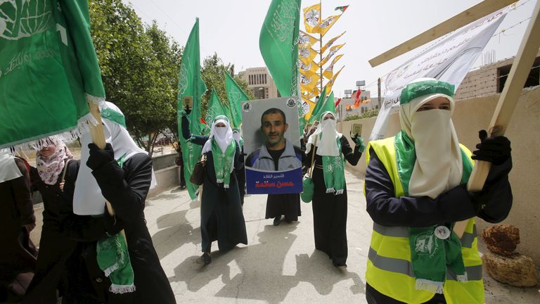 Palestinian students hold a poster depicting Hassan Salama during a West Bank demonstration in 2015. File pic: Reuters
