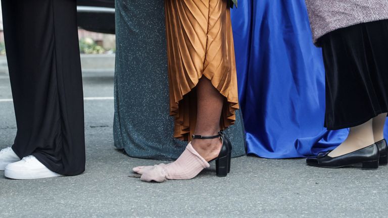A person wears socks on shoes, as people queue to enter Liberty Inauguration ball.
Pic: Reuters