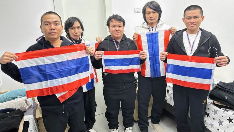 CORRECTS ID - Thai hostages who were freed from Hamas, from left to right, Surasak Rumnao, Sathian Suwannakham, Bannawat Saethao, Watchara Sriaoun, and Pongsak Thaenna hold the Thailand flag in Israel, Thursday, Jan. 30, 2025. (Royal Thai Embassy in Tel Aviv via AP)