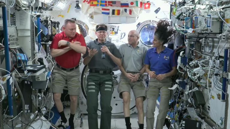 Astronauts give a press conference from the International Space Station.