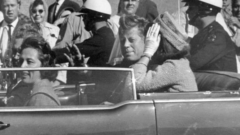 JFK waves from his car approximately one minute before he was shot. Pic: AP