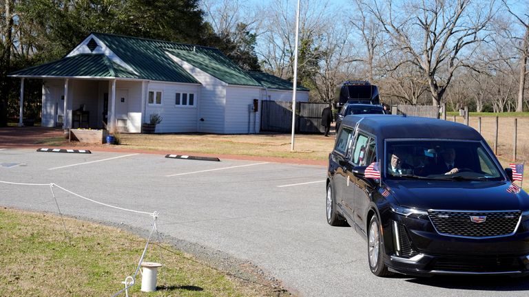 Jimmy Carter's coffin passes his boyhood farm in Archery, Georgia. Pic: Reuters