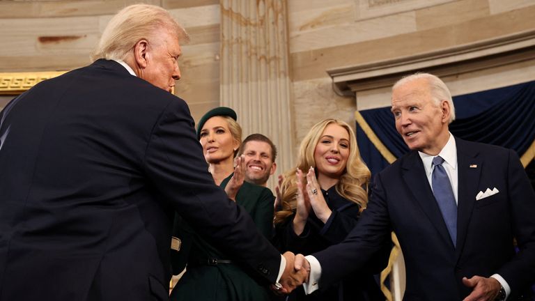 Donald Trump shakes hands with Joe Biden. Photo: Reuters