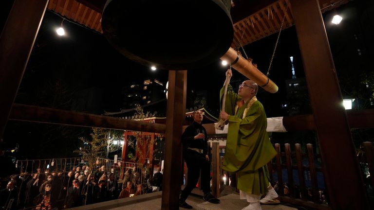 A monk hits the bell for the Joya no Kane ritual in Tokyo. Pic: AP