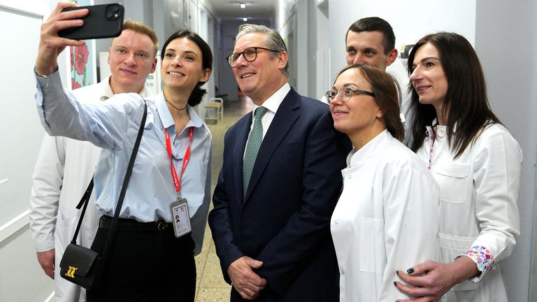 Keir Starmer poses for photos with staff members at a hospital in Kyiv.
Pic: PA