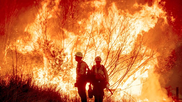 Fire crews battle the Kenneth Fire in the West Hills section of Los Angeles, Thursday, Jan. 9, 2025. (AP Photo/Ethan Swope)