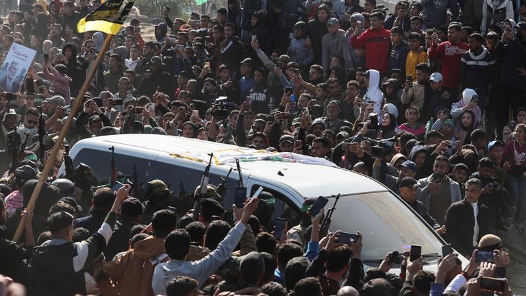 Militants carry rifles next to a vehicle, on the day they hand over hostages held in Gaza in Khan Younis.
Pic: Reuters