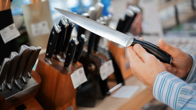 Person holding a knife in kitchenware shop. File pic: alexey_ds/iStock