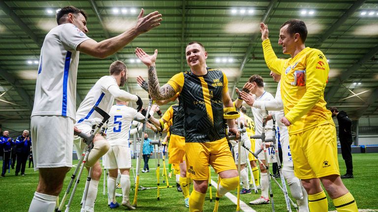 Soccer players of AMP FC Kyiv and Pokrova FC-2 greets each other during the first football tournament for war-wounded amputees in Kyiv, Ukraine, Jan. 12, 2025. (AP Photo/Evgeniy Maloletka)