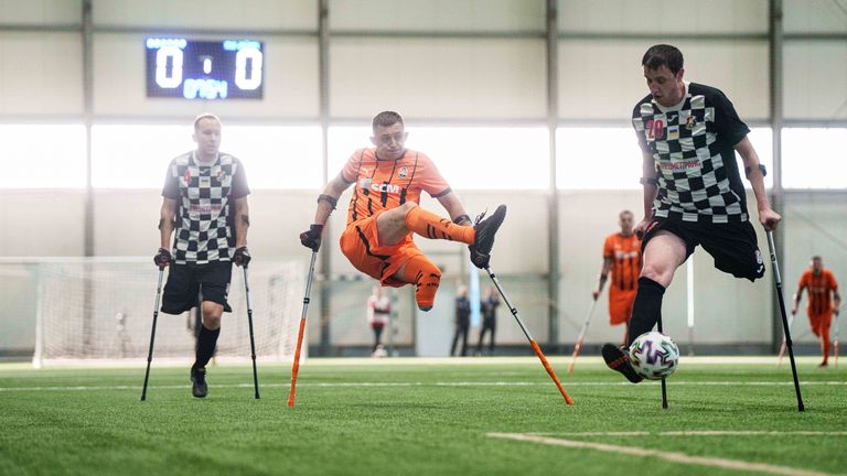 Soccer players of Shakhtar Stalevi and MSK Dnipro play during Ukraine's first soccer tournament for war-wounded amputees in Kyiv, Ukraine, Jan. 11, 2025. (AP Photo/Evgeniy Maloletka)
