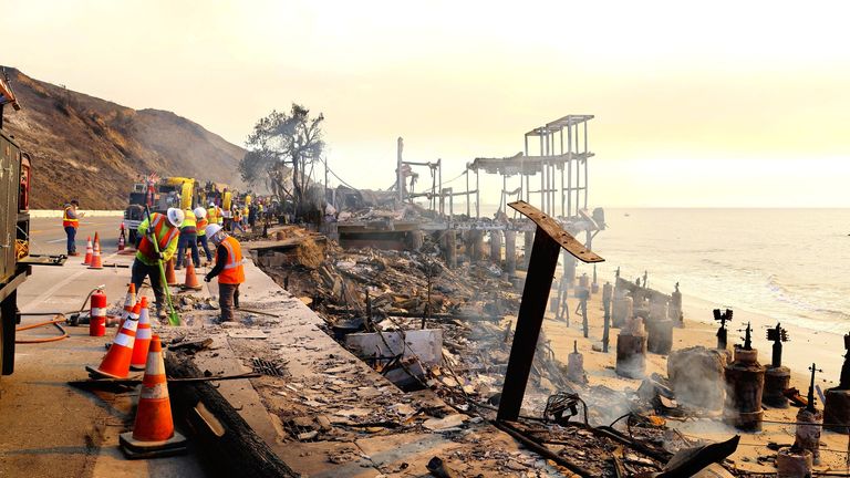 Workers at the ruins of wildfires in Pacific Palisades, Los Angeles on Saturday. Pic: The Yomiuri Shimbun via AP