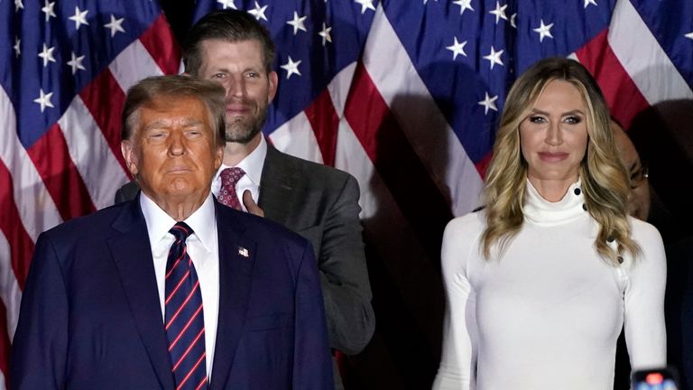 Lara Trump, with Mr Trump and her husband Eric Trump behind his father. Pic: AP