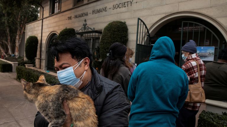 Edgar Hernandez outside the Pasadena Humane Society before he surrenders his cat, after evacuating his home in Altadena.
Pic: Reuters/Zaydee Sanchez