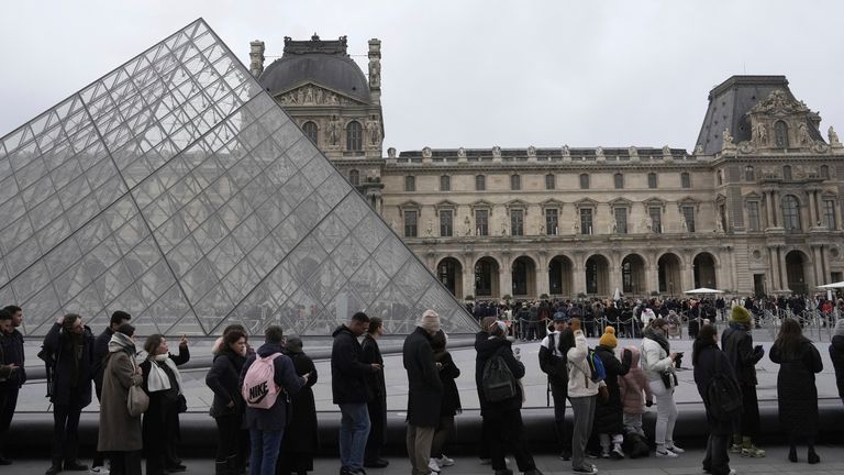 People line up to enter the Louvre museum, Monday, Jan. 27, 2025 in Paris. (AP Photo/Thibault Camus)