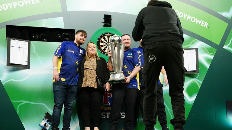 Littler photographed with his family on stage after historic win. Pic: PA