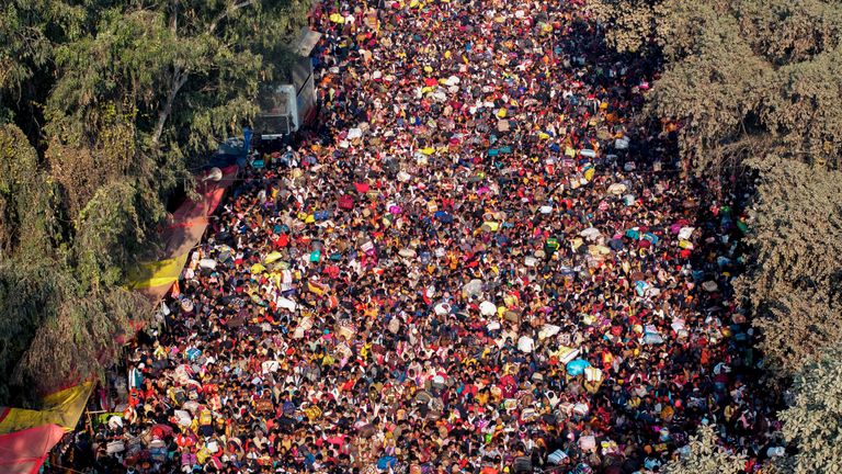 Indian Hindu devotees arrive for a holy dip at Sangam, the confluence of the Ganges, the Yamuna and the mythical Saraswati rivers, on the eve of the 'Mauni Amavasya' or new moon day during the Maha Kumbh festival, in Prayagraj, Uttar Pradesh, India, Tuesday, Jan. 28, 2025. (AP Photo/Rajesh Kumar Singh)