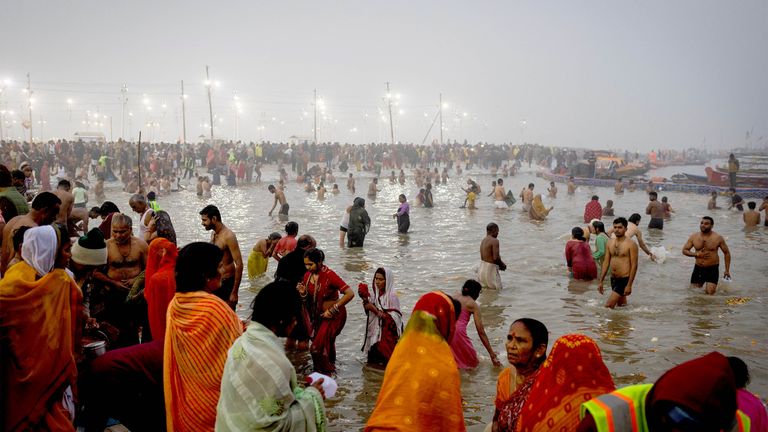 Devotees take a holy dip at Sangam, the confluence of the Ganges and Yamuna rivers with the mythical, invisible Saraswati river, during the "Maha Kumbh Mela", or the Great Pitcher Festival, in Prayagraj, India, January 13, 2025. REUTERS/Adnan Abidi