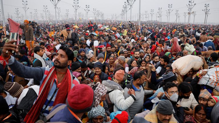 Devotees gather at the "Maha Kumbh Mela", or the Great Pitcher Festival as they take a holy dip at Sangam, the confluence of the Ganges and Yamuna rivers with the mythical, invisible Saraswati river, in Prayagraj, India, January 13, 2025. REUTERS/Anushree Fadnavis

