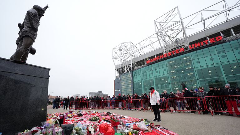 Tributes to Denis Law were laid at the foot of the statue of the United Trinity at Old Trafford. Pic: PA