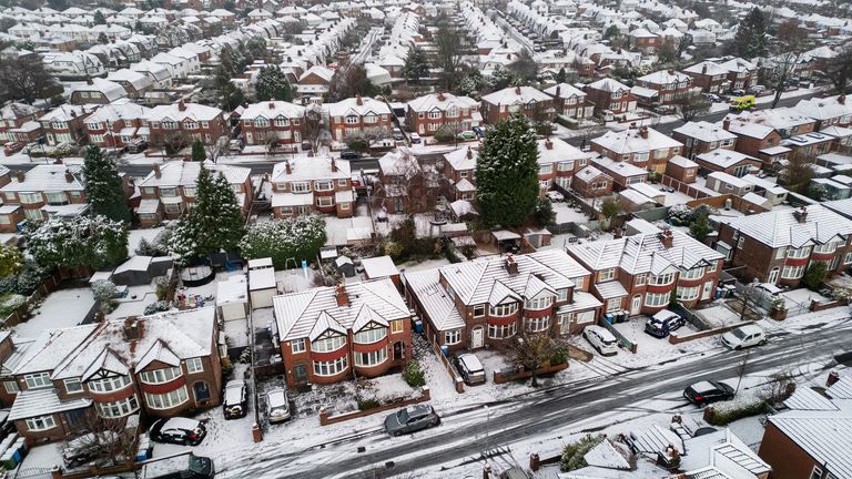 A drone view shows snow covering the rooftops of houses in Manchester.
Pic: Reuters