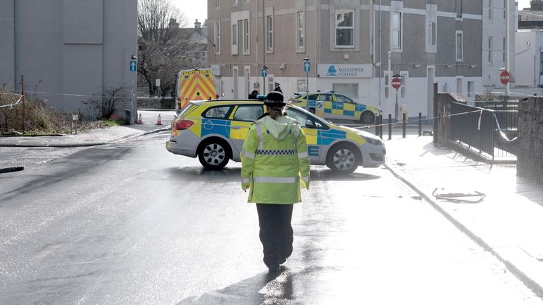 A police officer on West Hoe Road in Plymouth, Devon, where a manhunt is under way.
Pic: PA