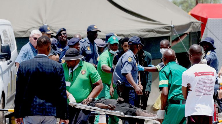 A rescued miner is carried in a stretcher by medical staff.
Pic: Reuters