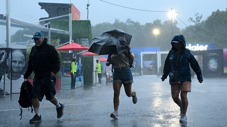 Thunderstorms left spectators scurrying for cover. Pic: Reuters