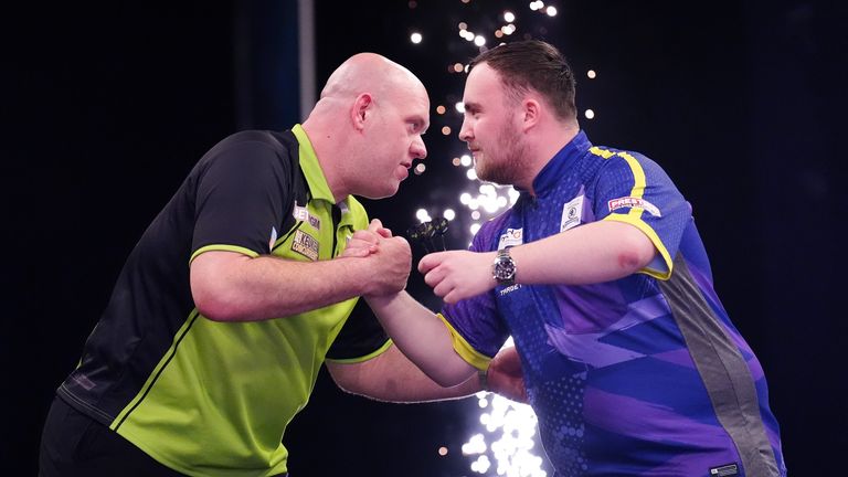 Michael van Gerwen embraces Luke Littler after winning Premier League match in May. Pic: PA