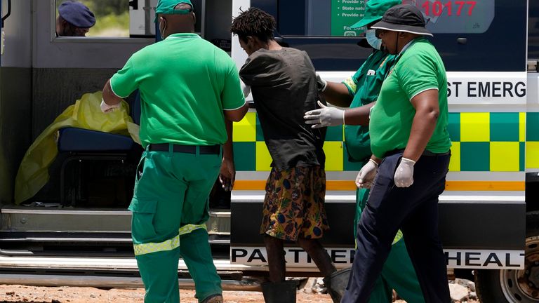 Rescuer workers assist an illegal miner who has been trapped deep in an abandoned gold mine for months, in Stilfontein, South Africa.
Pic: AP