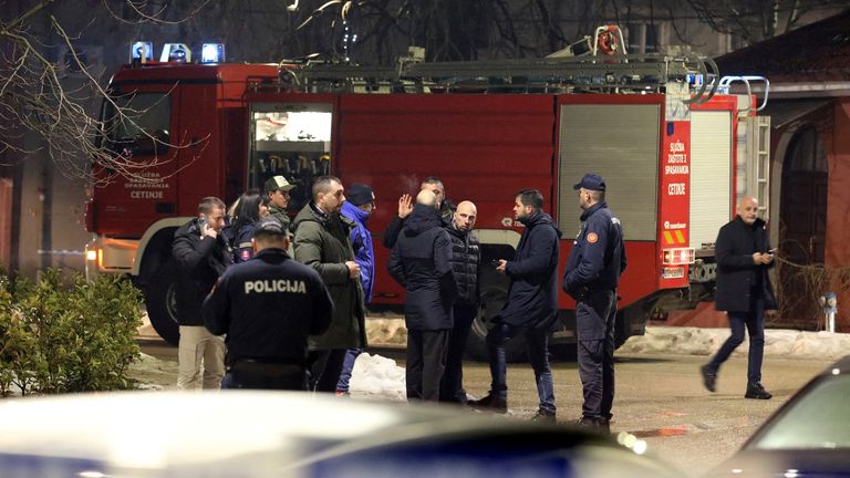 Police and security personnel stand on a street in front of a fire engine near the scene where a gunman opened fire. Pic: Reuters