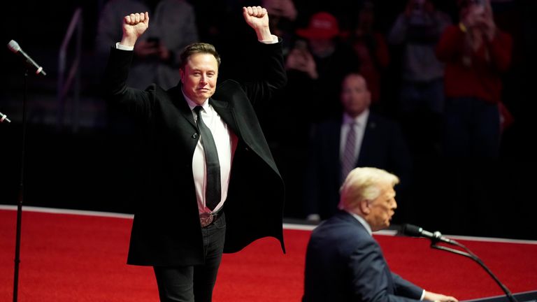 Elon Musk reacts as President Donald Trump speaks the night before his inauguration. Pic: AP