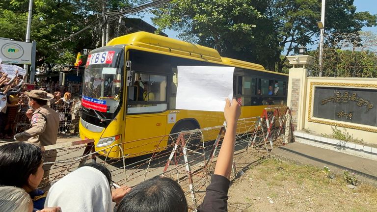 Released prisoners, in a bus, are welcomed by family members and colleagues after they left Insein Prison Saturday, Jan. 4, 2025, in Yangon, Myanmar. (AP Photo/Thein Zaw)