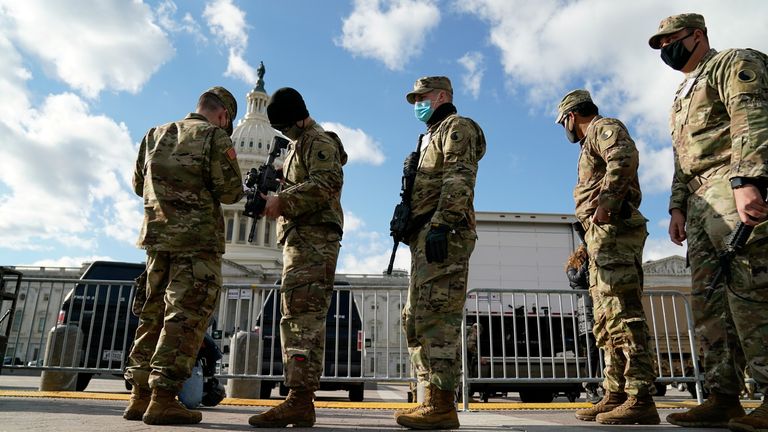 National guard troops receive guns at the U.S. Capitol as security tightens ahead of presidential inaugural events on Capitol Hill in Washington, U.S., January 17, 2021. REUTERS/Erin Scott