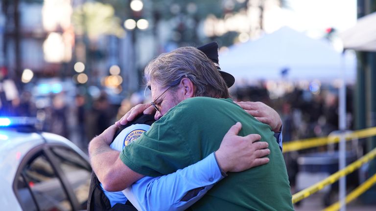 A man hugs a police officer at the scene in New Orleans French Quarter. Pic: AP