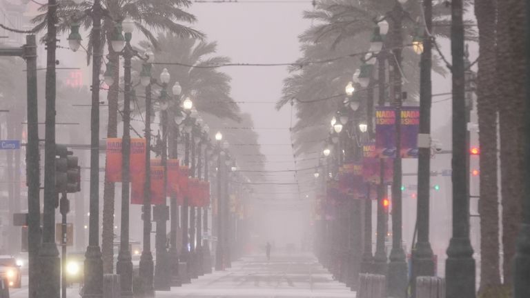 Snow blankets Canal Street in downtown New Orleans, Tuesday, Jan. 21, 2025. (AP Photo/Gerald Herbert)