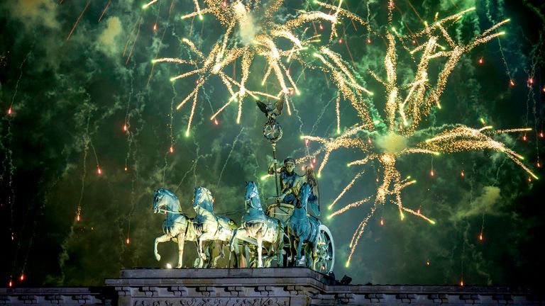 Fireworks light the sky above the Quadriga at the Brandenburg Gate during New Year's celebrations shortly after midnight in Berlin, Germany, Wednesday, Jan. 1, 2025. (AP Photo/Ebrahim Noroozi)