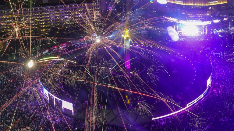 Fireworks explode as thousands of people gather in the main business district on New Year's Eve in Jakarta, Indonesia, Tuesday, Dec. 31, 2024. (AP Photo/Tatan Syuflana)