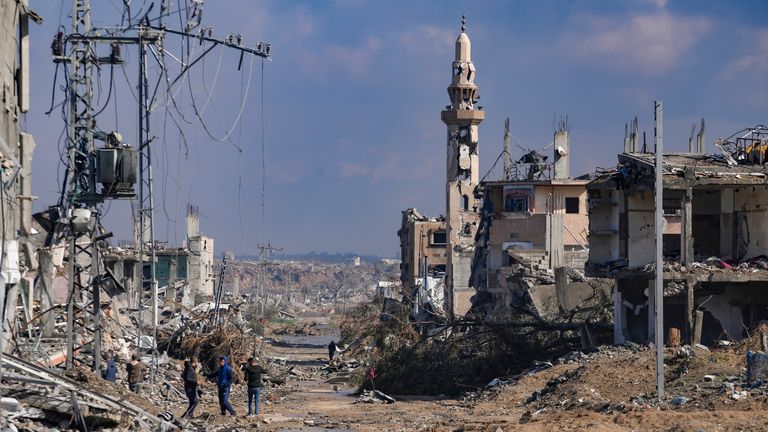 Palestinians walk past a mosque destroyed by the Israeli airstrikes in Nuseirat, Gaza.
Pic: AP