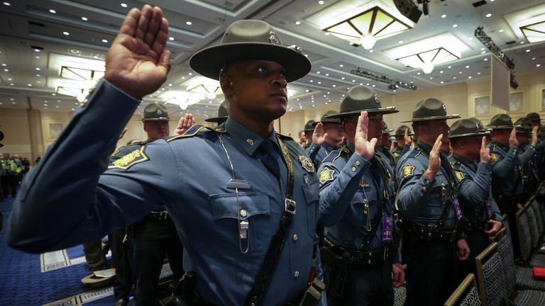 Officers from the Arkansas State Police along with thousands of other external law enforcement officers from across the United States attend a swearing-in ceremony ahead of performing security duties in Washington during the Inauguration of U.S. President-elect Donald Trump, in Oxon Hill, Maryland, U.S., January 19, 2025. REUTERS/Mike Segar