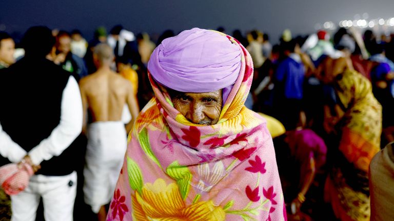 A devotee looks on at the river bank on the day they take a holy dip at Sangam, the confluence of the Ganges, Yamuna and mythical, invisible Saraswati rivers, during the "Maha Kumbh Mela", or the Great Pitcher Festival, in Prayagraj, India, January 13, 2025. REUTERS/Anushree Fadnavis