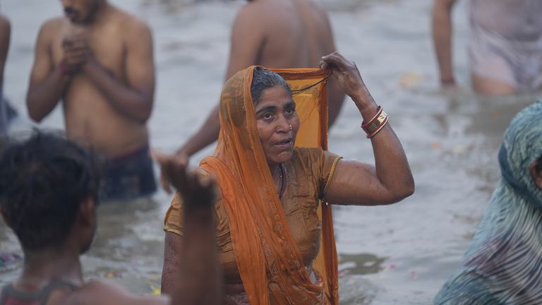 Hindu devotees take a holy dip by the banks of the Sangam, the confluence of the Ganges, the Yamuna and the mythical Saraswati rivers, on "Mauni Amavasya" or new moon day during the Maha Kumbh festival in Prayagraj, Uttar Pradesh, India, Wednesday, Jan. 29, 2025. (AP Photo/Deepak Sharma)