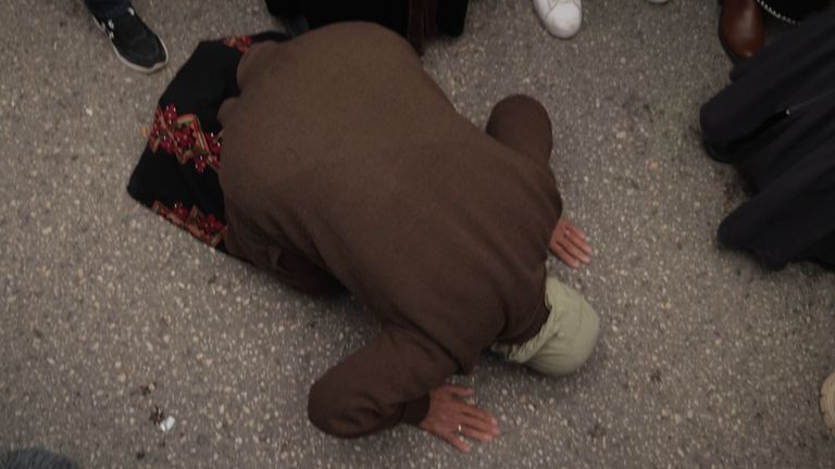 Safia dropped to her knees to pray as her son, Ismail, arrived back from an Israeli prison