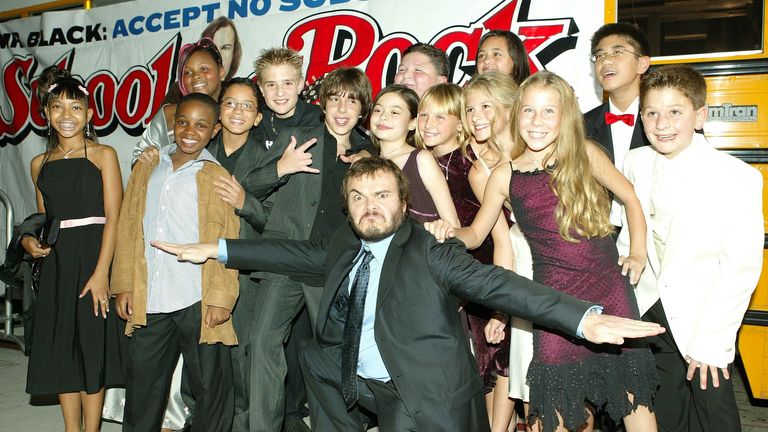 Caitlin Hale (second from right, front row) and Angelo Massagli (third from right, back row) with the cast in 2003. Pic: Bei/Shutterstock