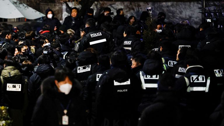 Police officers gather near the official residence of the impeached South Korean President Yoon Suk Yeol, as authorities are seeking to execute an arrest warrant, in Seoul, South Korea, January 15, 2025. REUTERS/Tyrone Siu